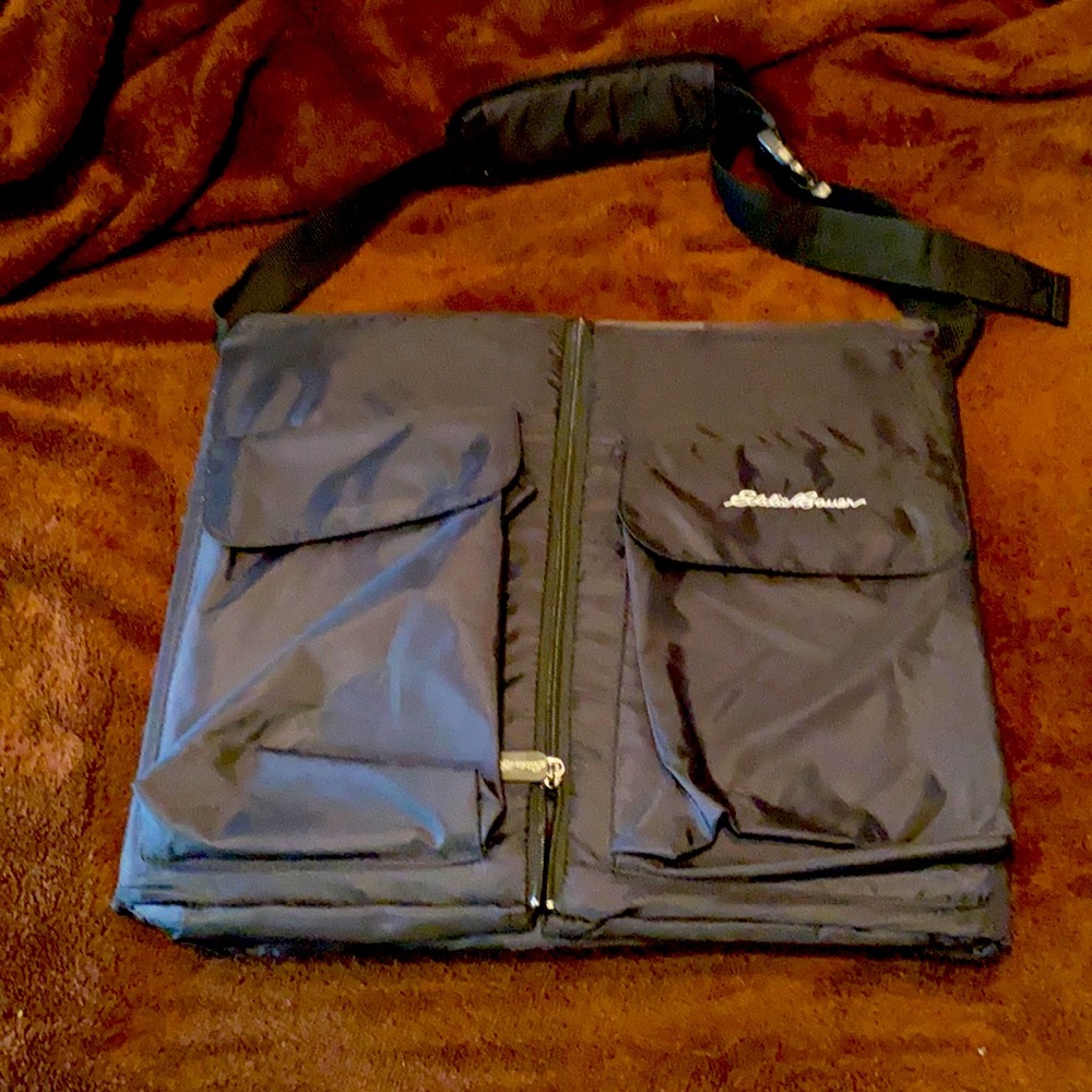 Eddie Bauer Portable Baby Changing table/portable bassinet. Unzips open. Pockets